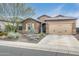 Single-story house with beige exterior, two-car garage, and desert landscaping at 5927 E Sienna Bouquet Pl, Cave Creek, AZ 85331