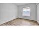 Well-lit bedroom featuring wood-look tile flooring and window at 629 N Mesa Dr # 29, Mesa, AZ 85201