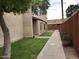 View of the building exterior, walkway, and landscaping at 629 N Mesa Dr # 29, Mesa, AZ 85201