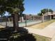 Community pool area with surrounding fence and walkway at 629 N Mesa Dr # 29, Mesa, AZ 85201