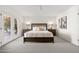 Main bedroom with dark brown bed frame, neutral decor, and access to a patio at 6309 N 14Th St, Phoenix, AZ 85014