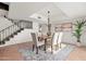 Spacious dining area with a modern chandelier and staircase view at 6309 N 14Th St, Phoenix, AZ 85014