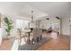 Spacious dining area with terracotta tile floors, chandelier, and adjacent living space at 6309 N 14Th St, Phoenix, AZ 85014