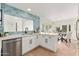 Modern white kitchen with stainless steel appliances and breakfast bar at 6309 N 14Th St, Phoenix, AZ 85014