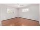 Bedroom with wood flooring, ceiling fan, and window shutters at 7513 E Minnezona Ave, Scottsdale, AZ 85251