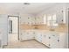 Classic kitchen with white cabinets, tile countertops and appliances at 7513 E Minnezona Ave, Scottsdale, AZ 85251