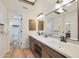 Modern bathroom with double vanity and large mirror at 7730 E Buena Terra Way, Scottsdale, AZ 85250