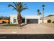 Single story home with gray garage door and landscaped front yard at 7730 E Buena Terra Way, Scottsdale, AZ 85250