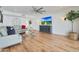 Living room featuring hardwood floors, sectional sofa, and large TV at 7730 E Buena Terra Way, Scottsdale, AZ 85250