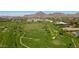 Aerial view of a golf course with mountain backdrop and residential area at 8 Biltmore Est # 123, Phoenix, AZ 85016