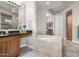 Spa-like bathroom with soaking tub and double vanity at 8 Biltmore Est # 123, Phoenix, AZ 85016