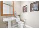 Elegant bathroom with pedestal sink, toilet and framed art at 8 Biltmore Est # 123, Phoenix, AZ 85016