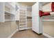 Spacious walk-in closet with built-in shelves and drawers at 8 Biltmore Est # 123, Phoenix, AZ 85016