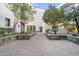 Landscaped courtyard with paved walkways and lush greenery at 8 Biltmore Est # 123, Phoenix, AZ 85016