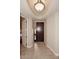 Elegant entryway with dark wood door and tile flooring at 8 Biltmore Est # 123, Phoenix, AZ 85016