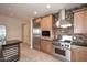 Modern kitchen, featuring stainless steel appliances and wood cabinetry at 8 Biltmore Est # 123, Phoenix, AZ 85016