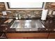 Modern kitchen sink with granite countertop and stylish tile backsplash at 8 Biltmore Est # 123, Phoenix, AZ 85016