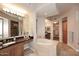 Luxurious bathroom with soaking tub, double vanity, and walk-in shower at 8 Biltmore Est # 123, Phoenix, AZ 85016