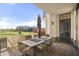 Outdoor patio with table, chairs, and umbrella, overlooking a golf course at 8 Biltmore Est # 123, Phoenix, AZ 85016