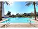 Inviting community pool with palm trees and tranquil atmosphere at 8 Biltmore Est # 123, Phoenix, AZ 85016