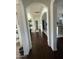 Elegant hallway with hardwood floors and arched doorways at 8210 S 132Nd Ave, Goodyear, AZ 85338