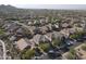 Aerial view of houses in a residential neighborhood with pools and solar panels at 9017 W Pinnacle Vista Dr, Peoria, AZ 85383