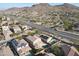 Aerial view showcasing a community of homes, featuring a house with a pool and solar panels at 9017 W Pinnacle Vista Dr, Peoria, AZ 85383