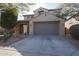 Two-story house with a gray garage door and stone accents at 9017 W Pinnacle Vista Dr, Peoria, AZ 85383