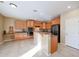 Open kitchen with breakfast bar, light wood cabinets, and views into the living area at 9017 W Pinnacle Vista Dr, Peoria, AZ 85383