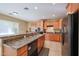 Modern kitchen with light wood cabinets, granite counters, and a breakfast bar at 9017 W Pinnacle Vista Dr, Peoria, AZ 85383