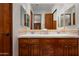 Double vanity bathroom with wood cabinets and neutral tile at 9111 E Mountain Spring Rd, Scottsdale, AZ 85255