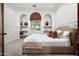 Guest bedroom with built-in shelves and window at 9111 E Mountain Spring Rd, Scottsdale, AZ 85255