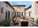 Private courtyard with stone patio and fireplace at 9111 E Mountain Spring Rd, Scottsdale, AZ 85255