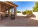 Landscaped backyard with gravel, covered patio and citrus tree at 9312 E Arrowvale Dr, Sun Lakes, AZ 85248