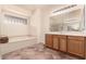 Bathroom features double vanity, soaking tub, and tile flooring at 9312 E Arrowvale Dr, Sun Lakes, AZ 85248