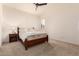 Bright bedroom with wood bed frame and ceiling fan at 9312 E Arrowvale Dr, Sun Lakes, AZ 85248