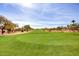 Green golf course with homes in background at 9312 E Arrowvale Dr, Sun Lakes, AZ 85248