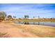 Golf course with lake and homes in the background at 9312 E Arrowvale Dr, Sun Lakes, AZ 85248