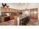 Kitchen features an island, extensive cabinetry, and granite countertops at 9312 E Arrowvale Dr, Sun Lakes, AZ 85248