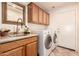 Laundry room with washer, dryer, and ample cabinet space at 9312 E Arrowvale Dr, Sun Lakes, AZ 85248