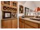 Wet bar with wine rack, granite countertop, and wood cabinetry at 9312 E Arrowvale Dr, Sun Lakes, AZ 85248