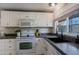 Well-equipped kitchen featuring white shaker cabinets and a stylish black sink at 9501 E Broadway Rd # 140, Mesa, AZ 85208