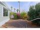 Landscaped side yard with stone pathway, lush plants, and desert landscaping at 9501 E Broadway Rd # 140, Mesa, AZ 85208