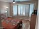 Bedroom with bay window, wood-look floors, and a comfortable bed at 10728 W Irma Ln, Sun City, AZ 85373