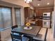 Bright kitchen with wood cabinets and eat-in area at 10728 W Irma Ln, Sun City, AZ 85373