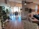 Bright living room with hardwood floors and access to the dining area at 10728 W Irma Ln, Sun City, AZ 85373