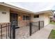 Brick entryway with wrought iron gate and small patio seating area at 10845 W Hatcher Rd, Sun City, AZ 85351