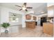 Kitchen with wood cabinets, black appliances, and breakfast bar at 10845 W Hatcher Rd, Sun City, AZ 85351