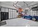 Spacious garage with overhead storage and a car lift at 10929 E North Ln, Scottsdale, AZ 85259