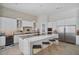Modern kitchen with white cabinets, large island, and brick backsplash at 10929 E North Ln, Scottsdale, AZ 85259